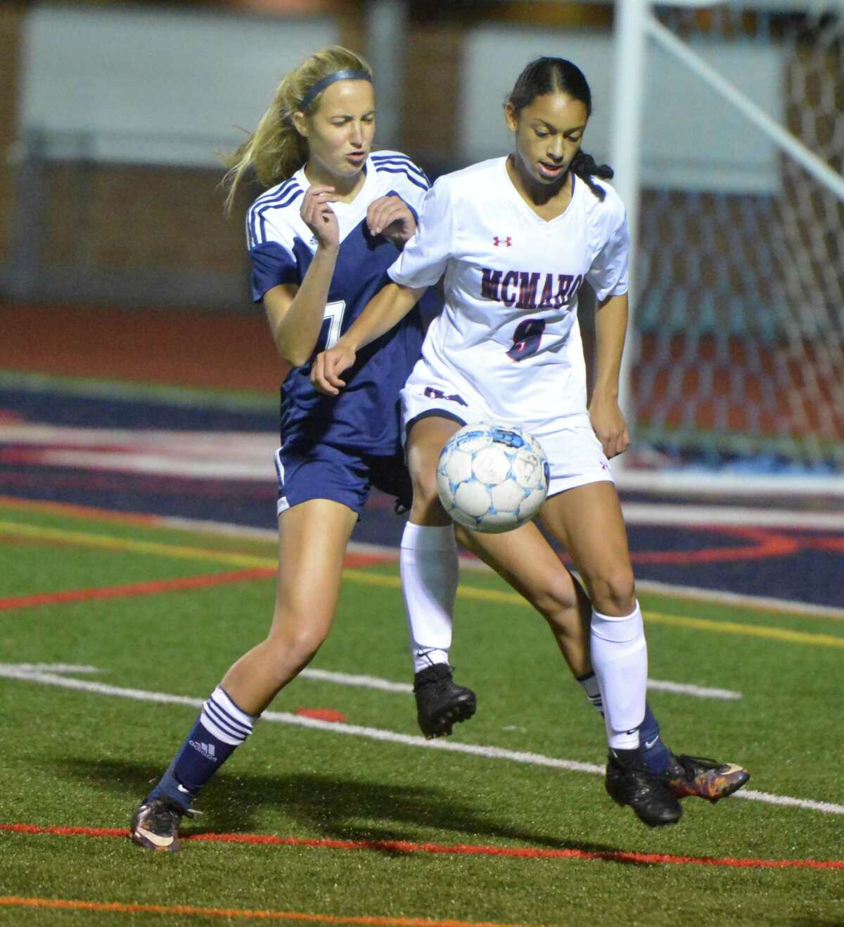 Brien McMahon's #9 Peyton McNamara gets the ball around a Wilton defender during girls soccer action vs. Wilton High School on Tuesday October 17, 2017 at Brien McMahon High School in Norwalk Conn.