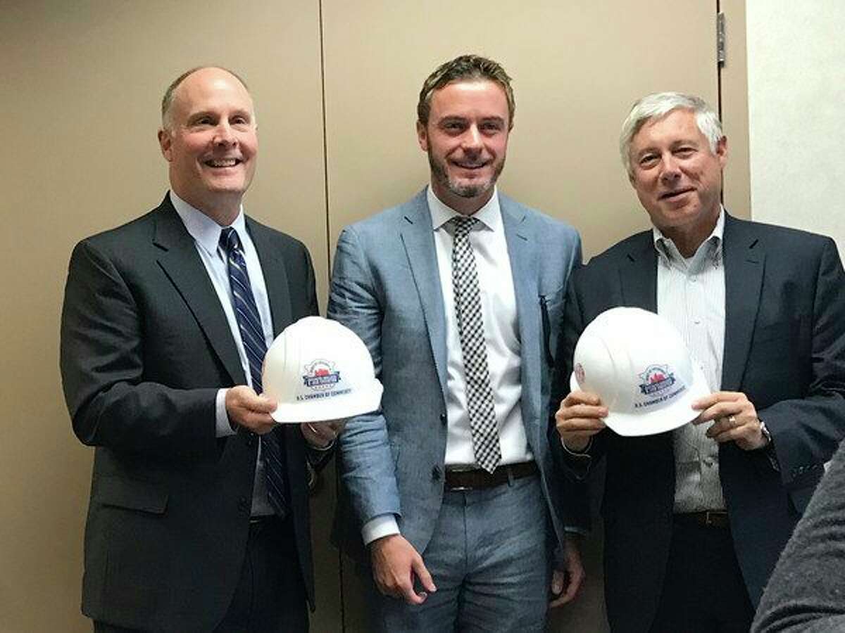 Ben Taylor, center, of the U.S. Chamber of Commerce, presents U.S. Reps. John Moolenaar, left, and Fred Upton with the Spirit of Enterprise Award during a Midland Area Chamber of Commerce Government Issues Committee meeting on Monday. (Photo provided)