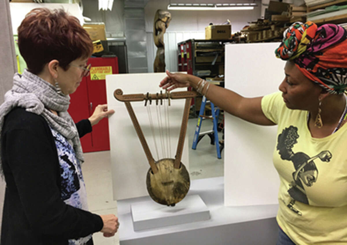 Visitors look at an item in the exhibit honoring Katherine Dunham in the Lovejoy Library on the SIUE campus.