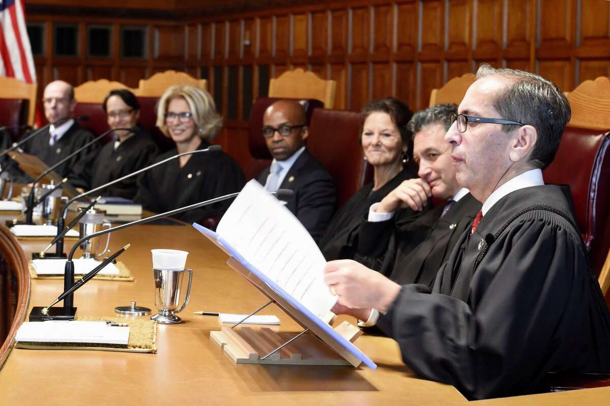 Associated Judge Paul Feinman, right, joins his colleagues on the state Court of Appeals on Wednesday.