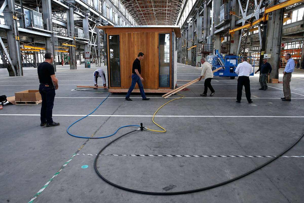 Workers conduct a test of their air casters used to move the modular structures around using hydraulic air, inside the huge building at Factory_OS where they are ramping up to build well-designed, tech-ready multifamily homes 40% faster and 20% less expensive than conventional housing on the grounds of the famous Mare Island Shipyard in Vallejo, Ca., as seen on Mon. September 11, 2017. 