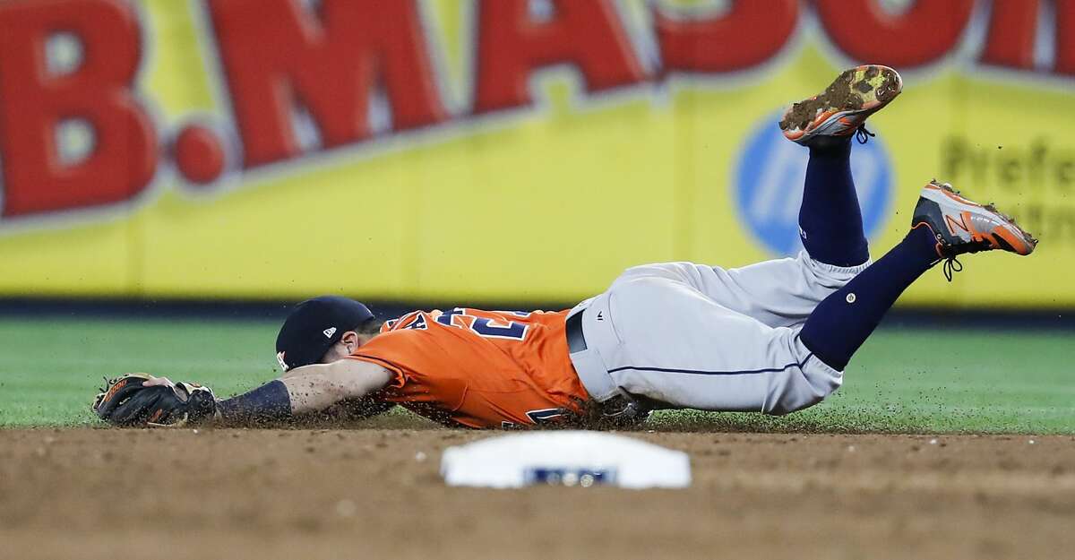 Houston Astros second baseman Jose Altuve dives and misses a grounder by New York Yankees shortstop Didi Gregorius, that went for a single, during the fifth inning of Game 5 of the ALCS at Yankee Stadium on Wednesday, Oct. 18, 2017, in New York. ( Karen Warren / Houston Chronicle )