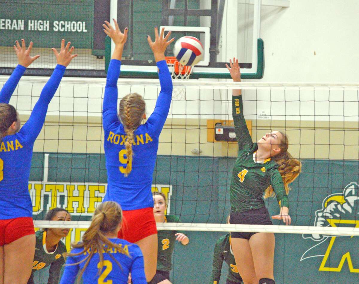 Metro-East Lutheran sophomore Alaina Bozarth, right, goes up for a kill during the first game of Wednesday’s home match against Roxana.