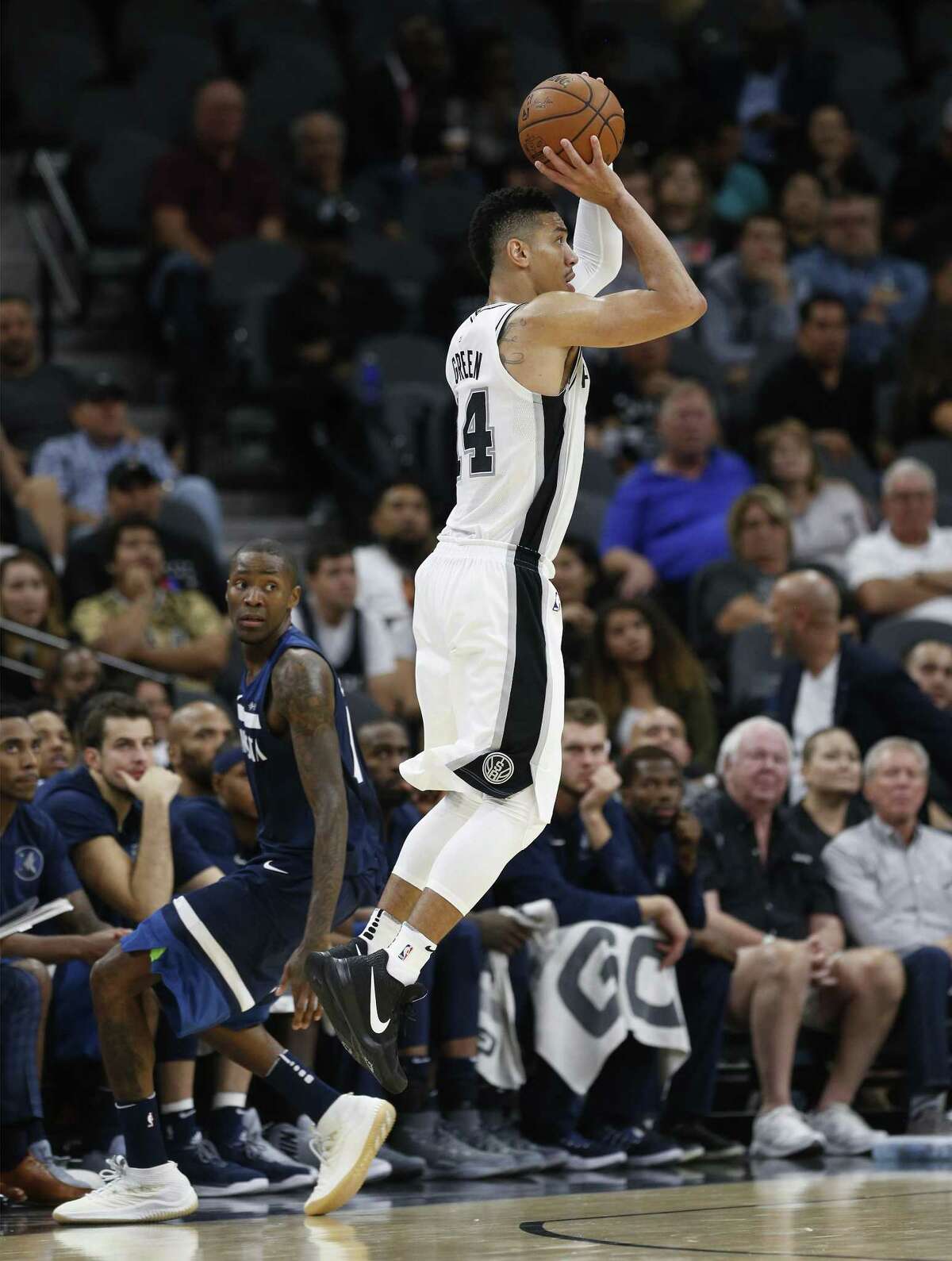 Spurs' Danny Green (14) shoots another three-pointer against Minnesota Timberwolves' Jamal Crawford (11) in the fourth at the AT&T Center on Wednesday, Oct. 18, 2017. Spurs defeated the T'Wolves, 107-99. (Kin Man Hui/San Antonio Express-News)