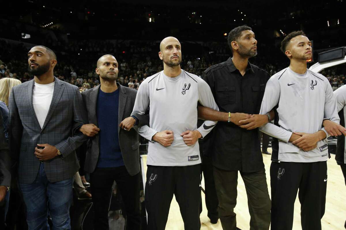 Spurs' players - current and former - including Tony Parker (second from left), Manu Ginobili, Tim Duncan and Kyle Anderson stand together with arms interlocked before the season opener against the Minnesota Timberwolves at the AT&T Center on Wednesday, Oct. 18, 2017. (Kin Man Hui/San Antonio Express-News)