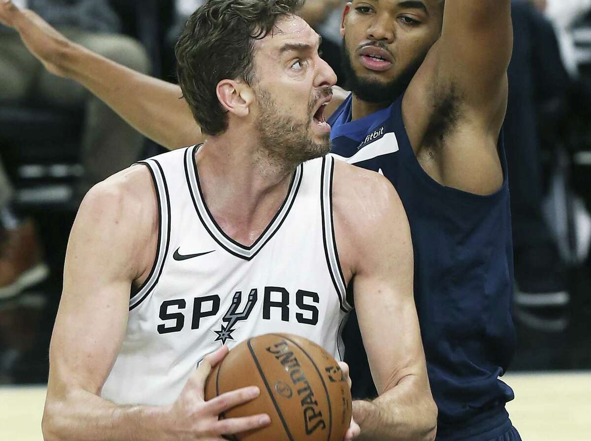Pau Gasol spins in the lane against Karl-Anthony Towns as the Spurs play Minnesota in the season opener at the AT&T Center on Oct. 18, 2017.