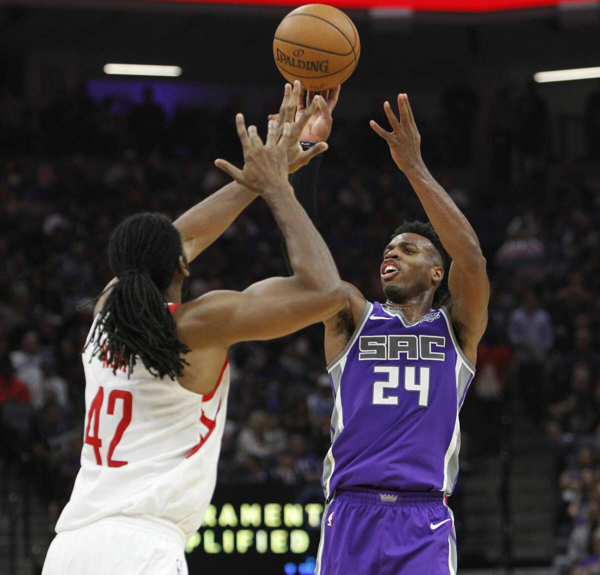 Sacramento Kings guard Buddy Hield (24) shoots over Houston Rockets defender Nene (42) during the second half of an NBA basketball game in Sacramento, Calif., Wednesday, Oct. 18, 2017. The Rockets won 105-100. (AP Photo/Steve Yeater)