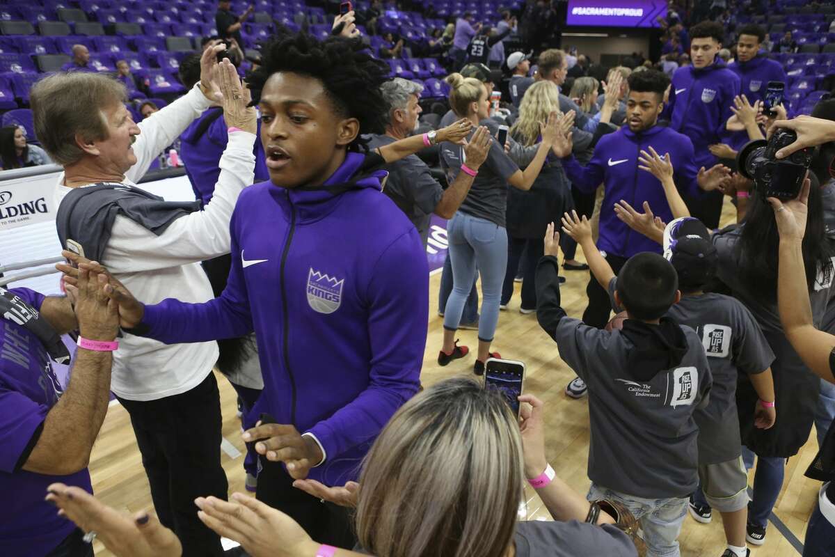 Sacramento Kings rookie guard De'Aaron Fox, left, is greeted by fans before their NBA basketball game against the Houston Rockets in Sacramento, Calif., Wednesday, Oct. 18, 2017. (AP Photo/Steve Yeater)