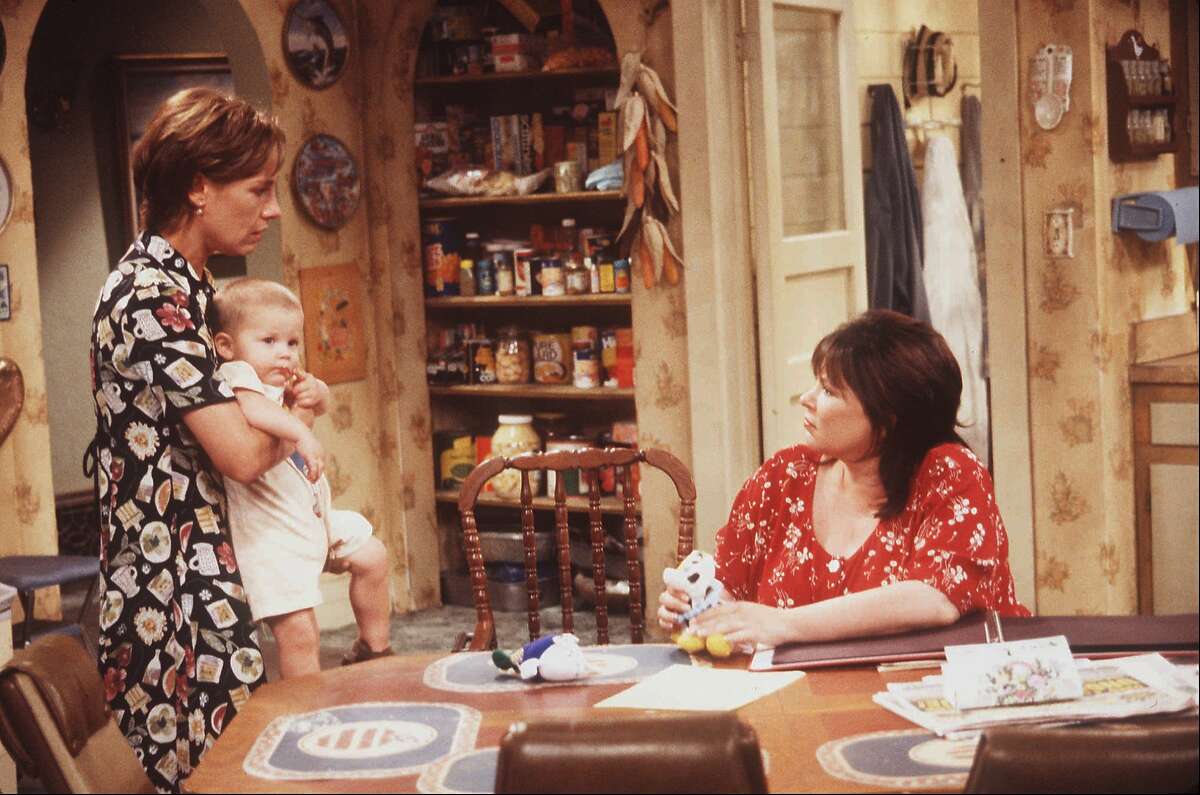 Larry Metcalf (left) appears along with Roseanne Barr in "Roseanne" in 1995.