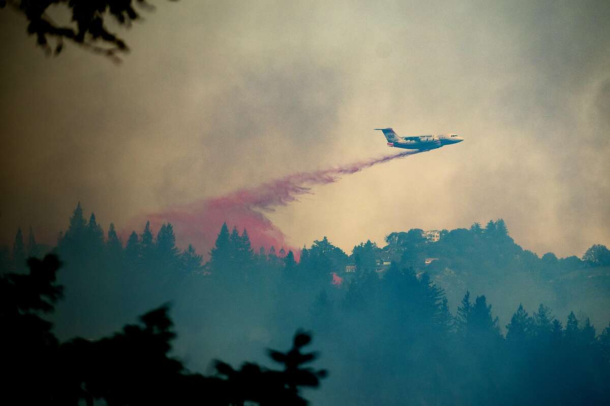 A tanker drops retardant on the Bear Bear fire in Boulder Creek, Calif., on Tuesday, Oct. 17, 2017.