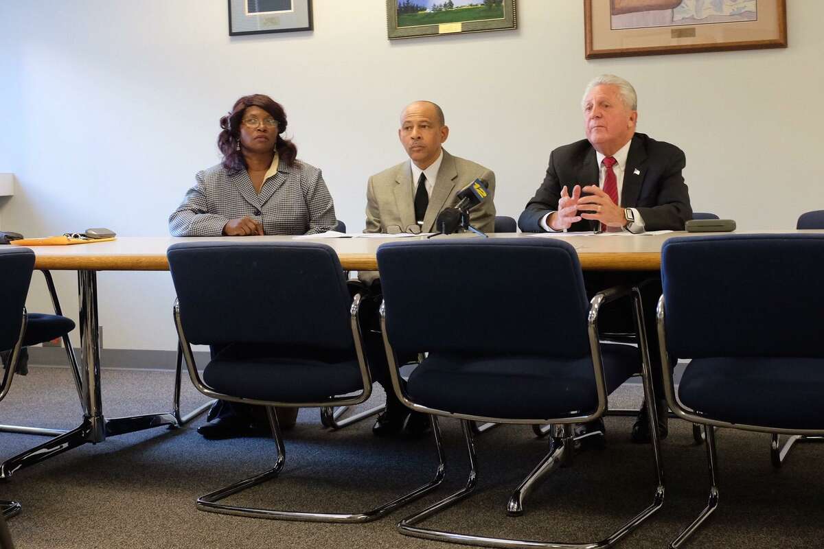 Daisy Franklin and Jeffrey Ingraham, of the Fair Housing Advisory Commission, present the findings of a report on housing discrimination with Mayor Harry Rilling on Oct.19.