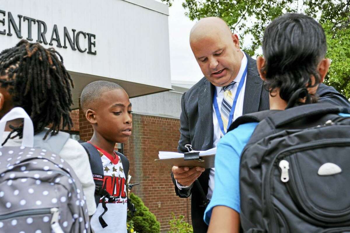 Middletown School Yes supporters are spreading the word to voters about the referendum question that, if passed, would allow construction to begin on a new $87.35 million grade six to eight Woodrow Wilson Middle School. Here, Assistant Principal David J. Mierzejewski helps seventh- and eighth-graders.