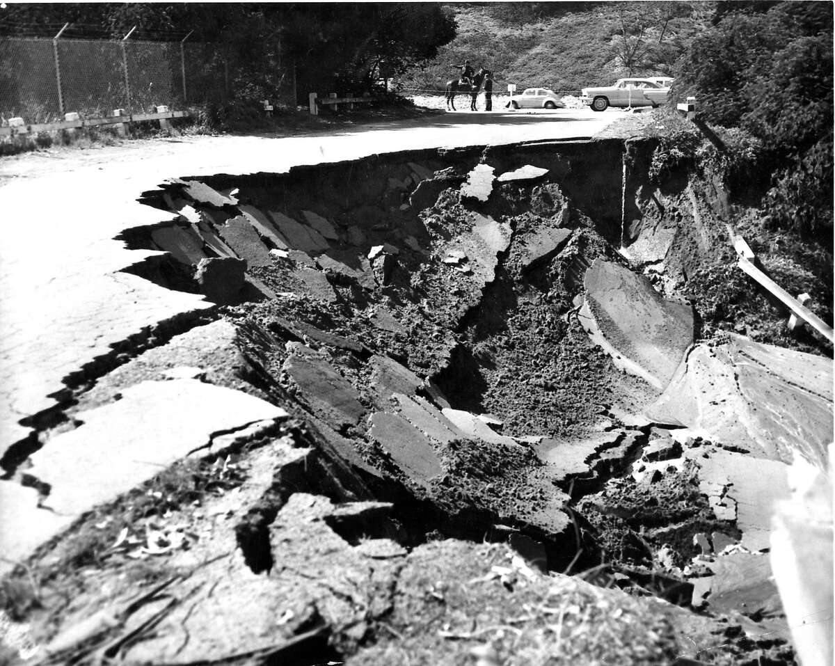 Police blocked the road as this section of the boulevard broke off into Lake Merced after the earthquake struck, March 22, 1957