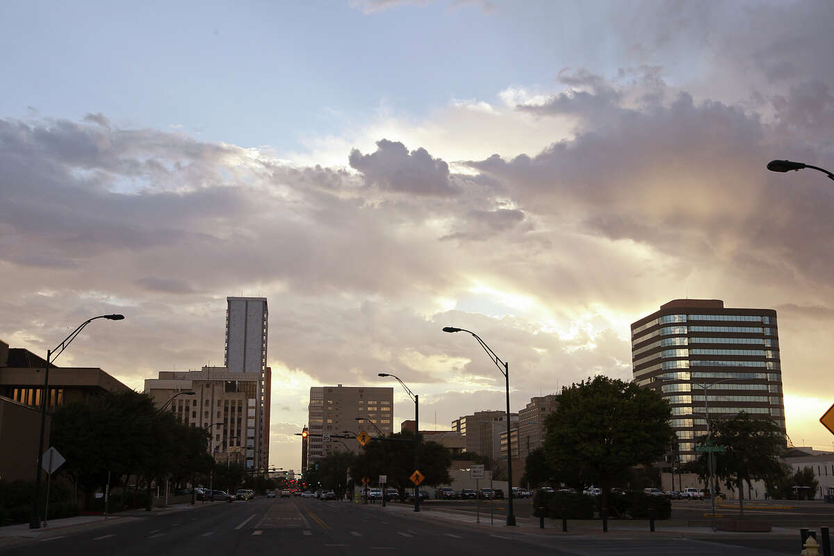 In this July 25, 2012 photo, the sun sets behind the Midland, Texas skyline.  (AP Photo/San Antonio Express-News, Jerry Lara) 