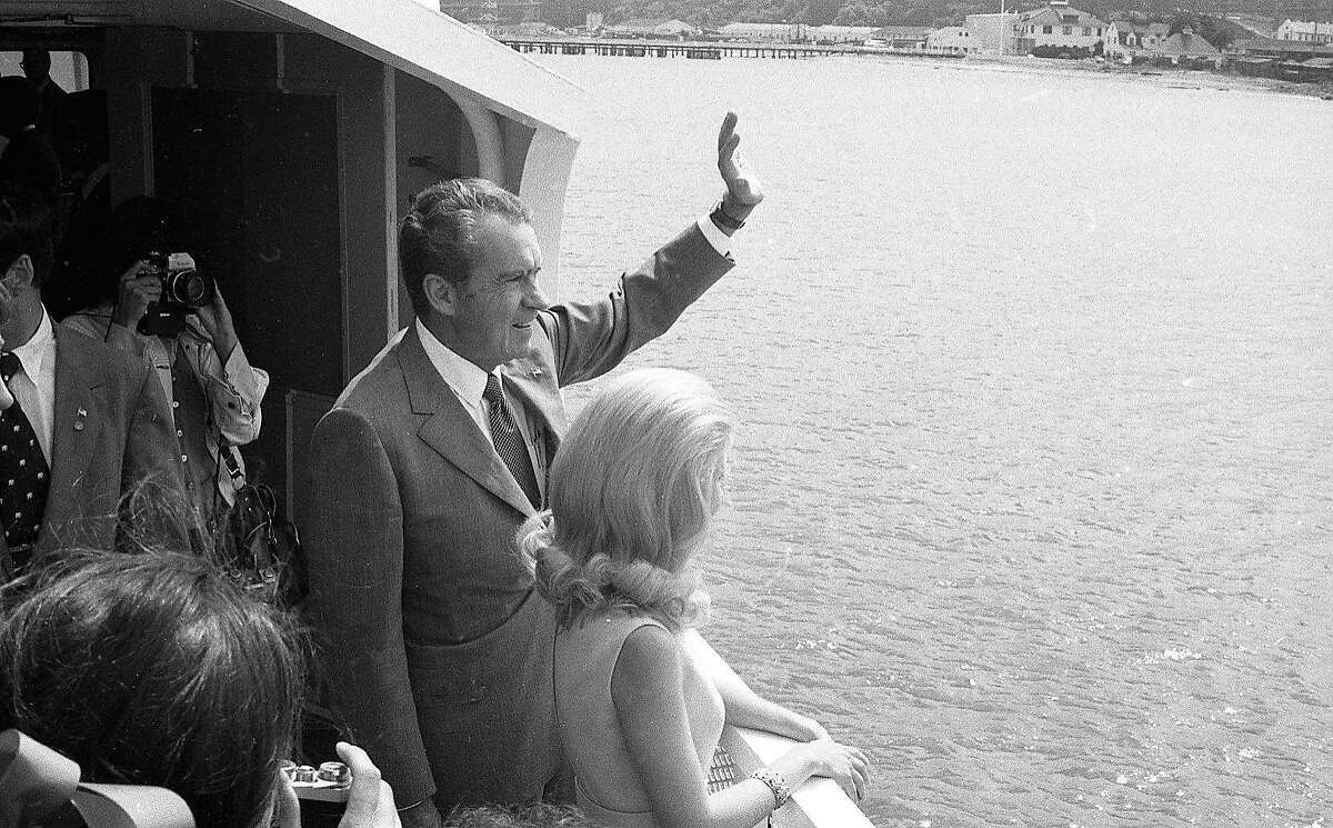 President Richard Nixon waves to another boat while on board a ferry in San Francisco Bay, where he was promoting his environment-friendly positions on Sept. 5, 1972.