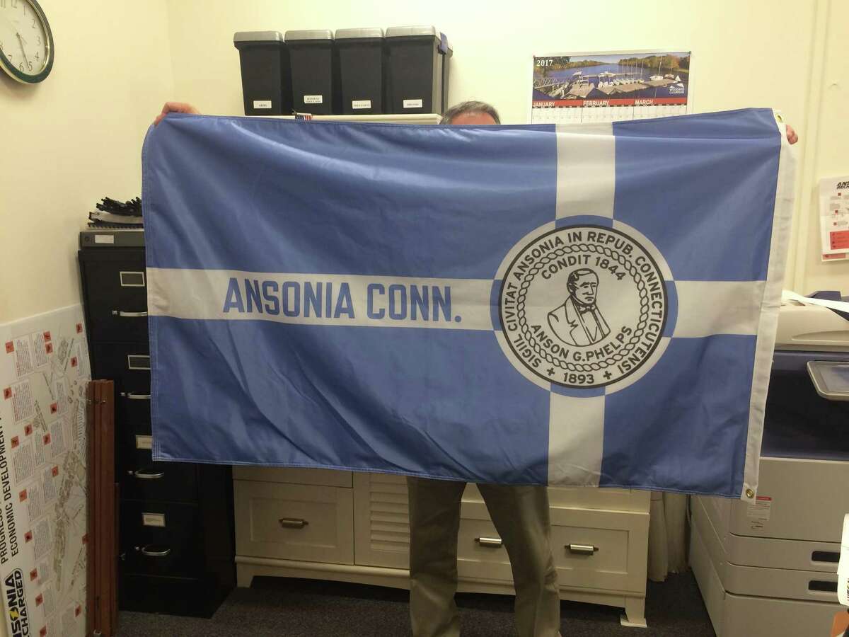 Greg Martin, Ansonia’s director of constitutent services, holds the city’s flag originally designed in 1965 which once again will fly outside city hall
