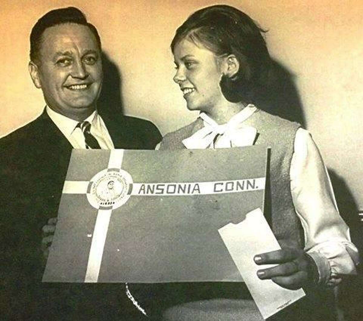 Former Ansonia Mayor Joseph Doyle presents Nancy Busk with a $25 savings bond in 1965 for her design of the city’s flag