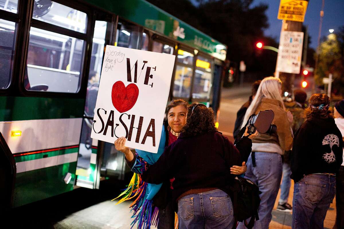 Ruth Villasenor receives a kiss from a friend upon arriving at a march in support of burn victim Sasha Fleischman, 18, outside Oakland High School in Oakland, Calif., Thursday, November 14, 2013.
