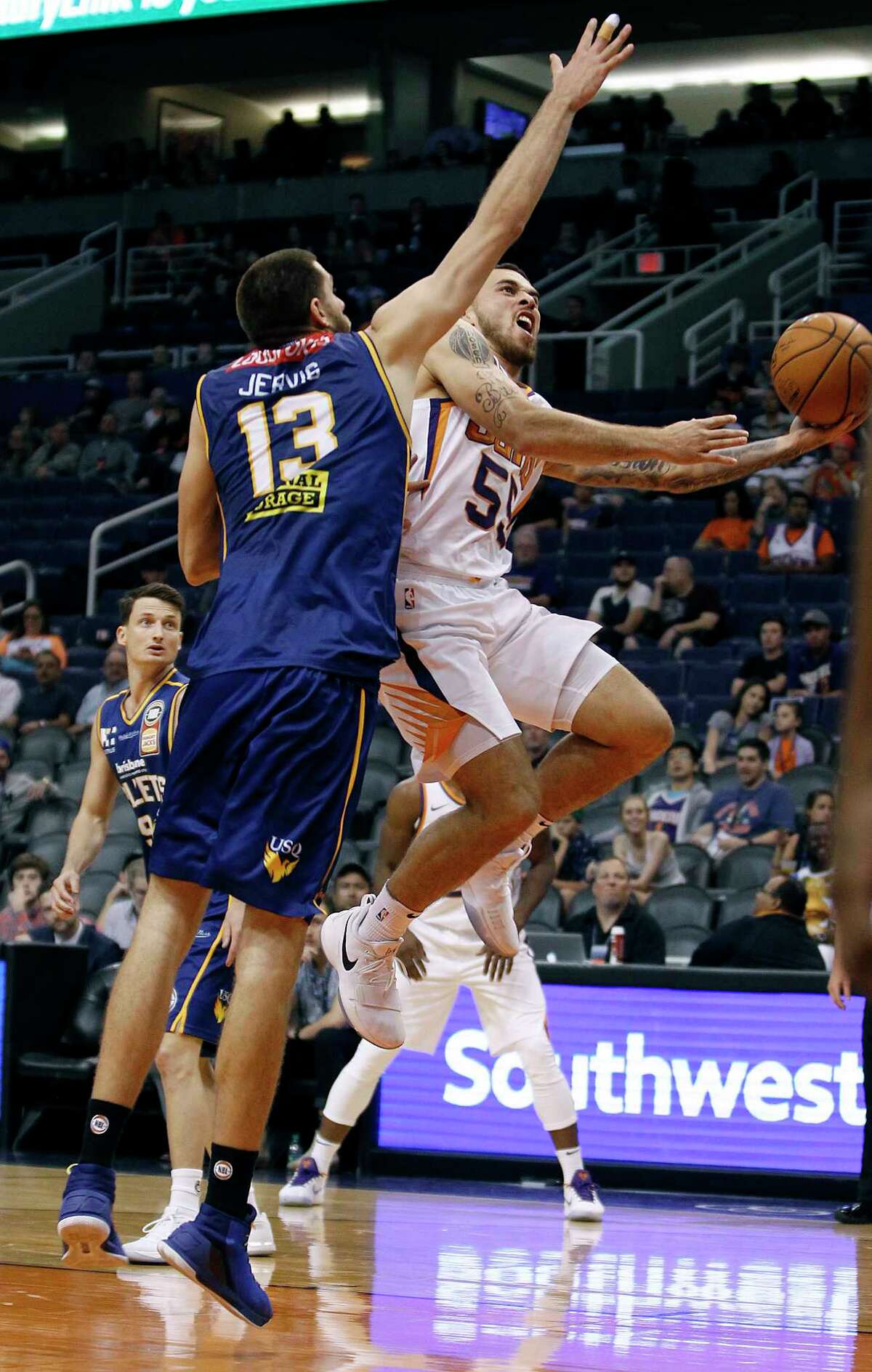 Phoenix Suns forward guard Mike James (55) drives to the basket as Brisbane Bullets forward Tom Jervis defends during the second half of an NBA basketball exhibition game Friday, Oct. 13, 2017, in Phoenix. (AP Photo/Ralph Freso)