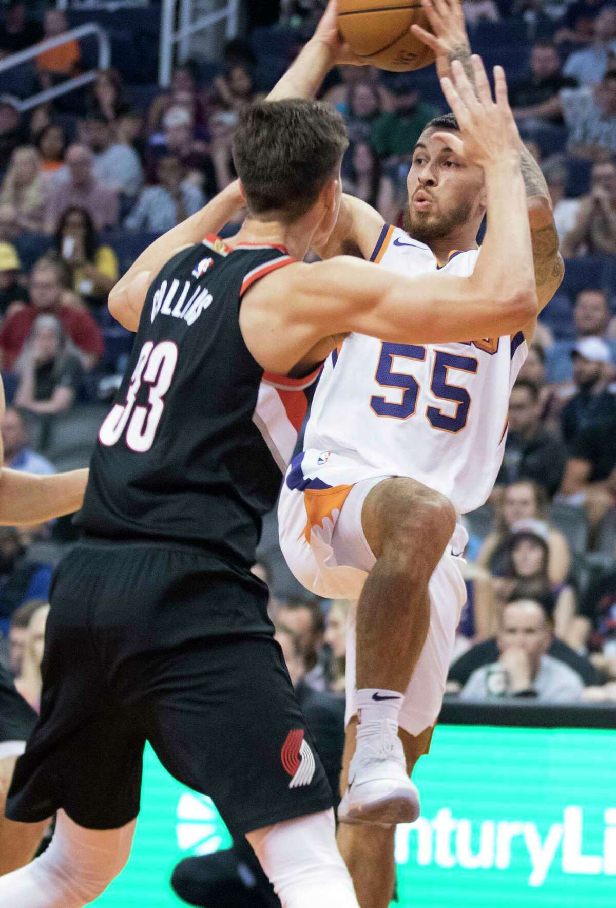 Phoenix Suns' Mike James (55) looks to pass the ball as Portland Trail Blazers' Zach Collins (33) defends during the first half of an NBA preseason basketball game Wednesday, Oct. 11, 2017, in Phoenix. (AP Photo/Darryl Webb)