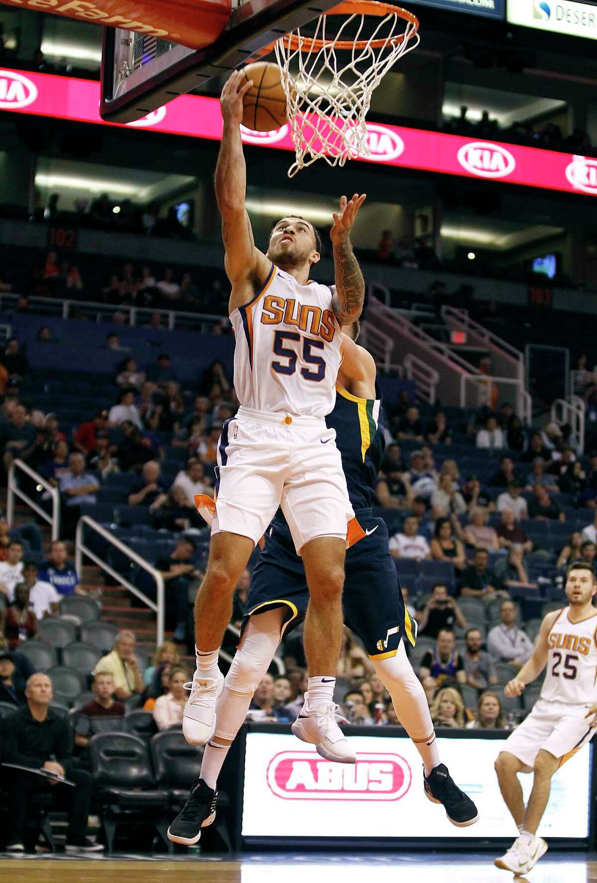 Phoenix Suns guard Mike James (55) drives to the basket past Utah Jazz's Jonas Jerebko during the second half of a preseason NBA basketball game Monday, Oct. 9, 2017, in Phoenix. The Jazz defeated the Suns 120-102. (AP Photo/Ralph Freso)
