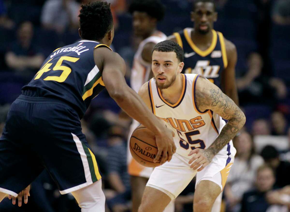 Phoenix Suns' Mike James (55) guards Utah Jazz's Donovan Mitchell during the second half of a preseason NBA basketball game Monday, Oct. 9, 2017, in Phoenix. The Jazz defeated the Suns 120-102. (AP Photo/Ralph Freso)