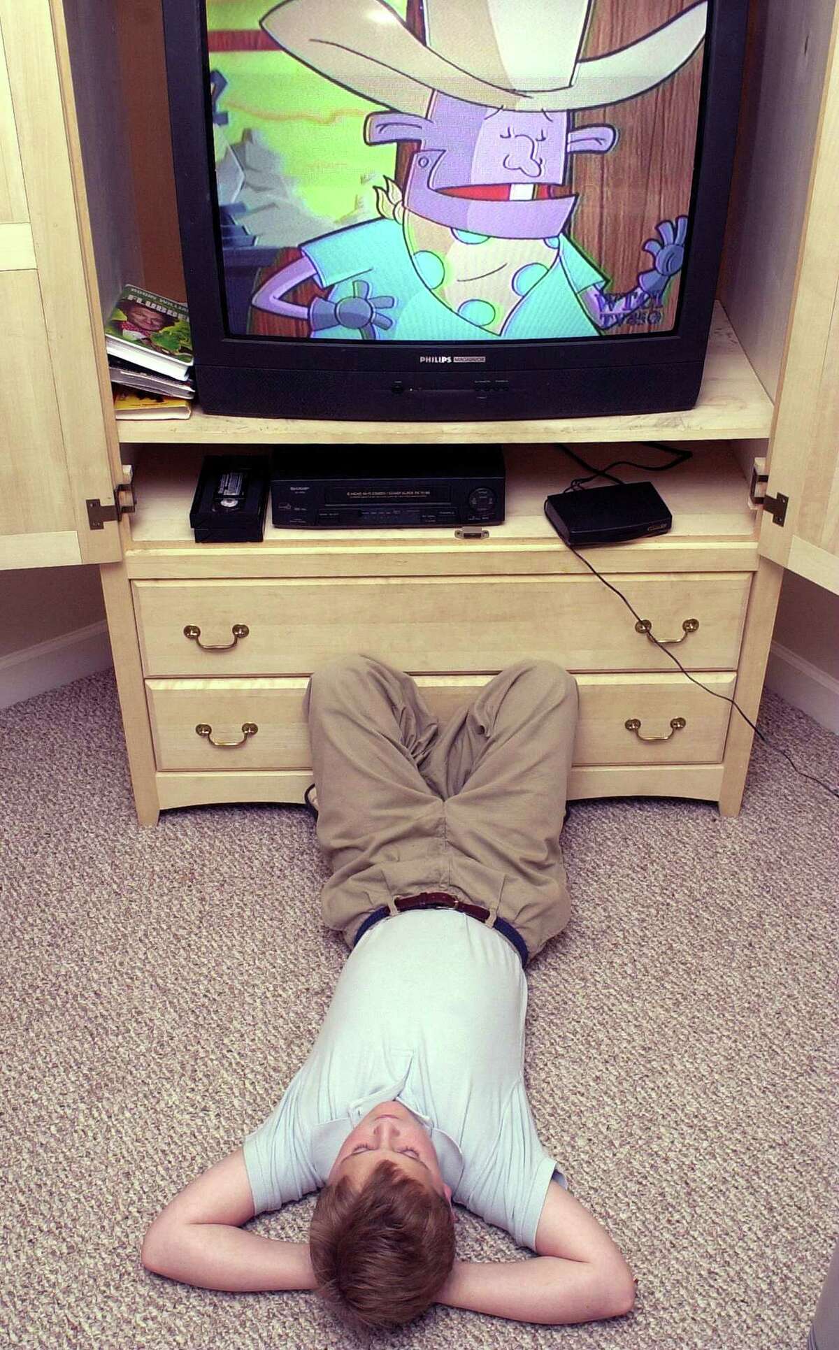 Spencer Renfrow watches television in his Chattanooga, Tenn., home Monday, April 8, 2002. Rebekah Renfrow purchased a ProtecTV box to filter profanity and other selected words from television programs. (AP Photo/Angela Lewis)