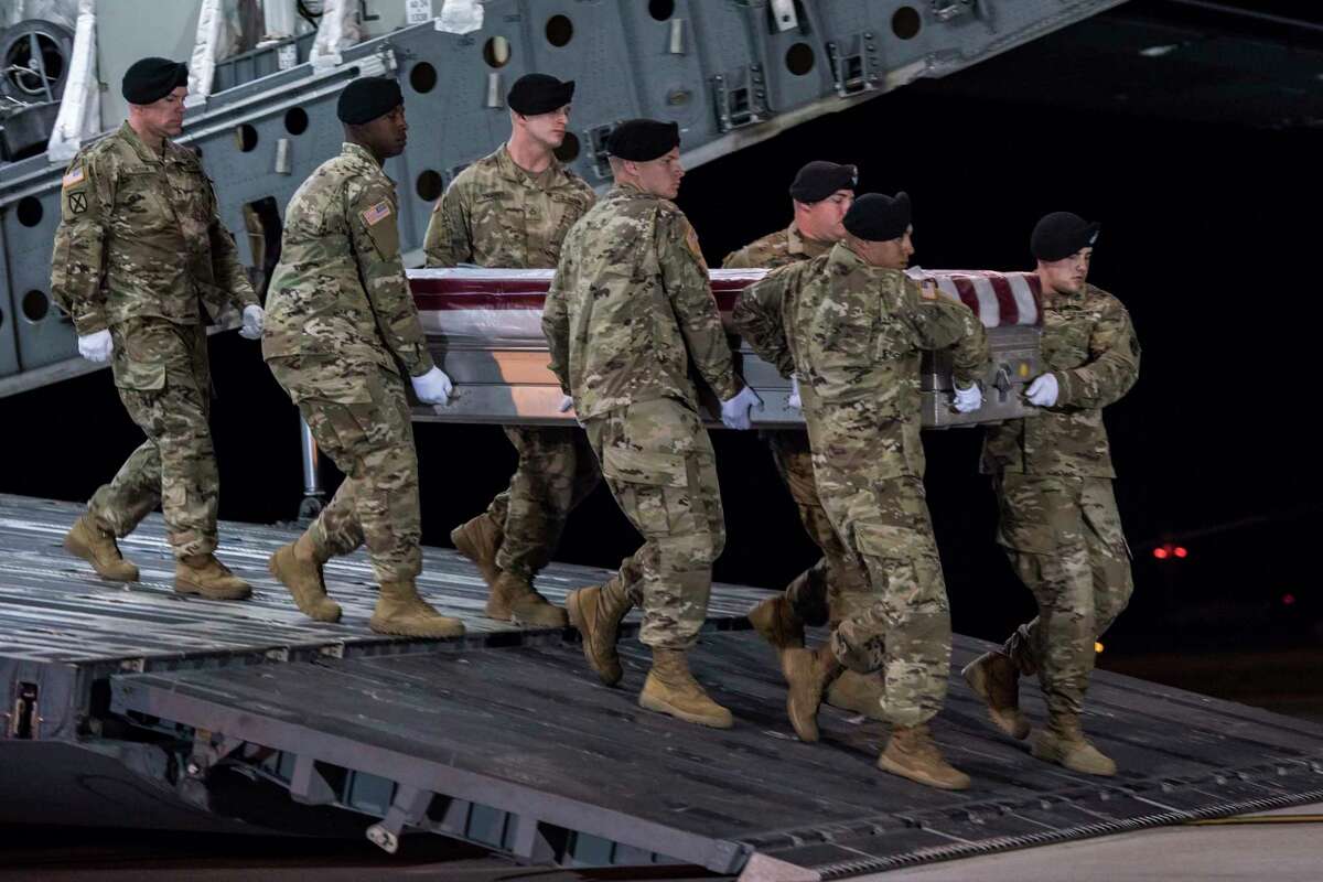 In this image provided by the U.S. Army, a carry team of soldiers from the 3d U.S. Infantry Regiment (The Old Guard), carry the transfer case during a casualty return for Staff Sgt. Dustin M. Wright, of Lyons, Ga., at Dover Air Force Base, Del., Oct. 5, 2017. U.S. and Niger forces were leaving a meeting with tribal leaders when they were ambushed on Oct. 4 and Wright and three other soldiers were killed. There were about a dozen U.S. troops and a company of Niger forces, for a total of about 40 service members in the joint mission. (Pfc. Lane Hiser/U.S. Army via AP)