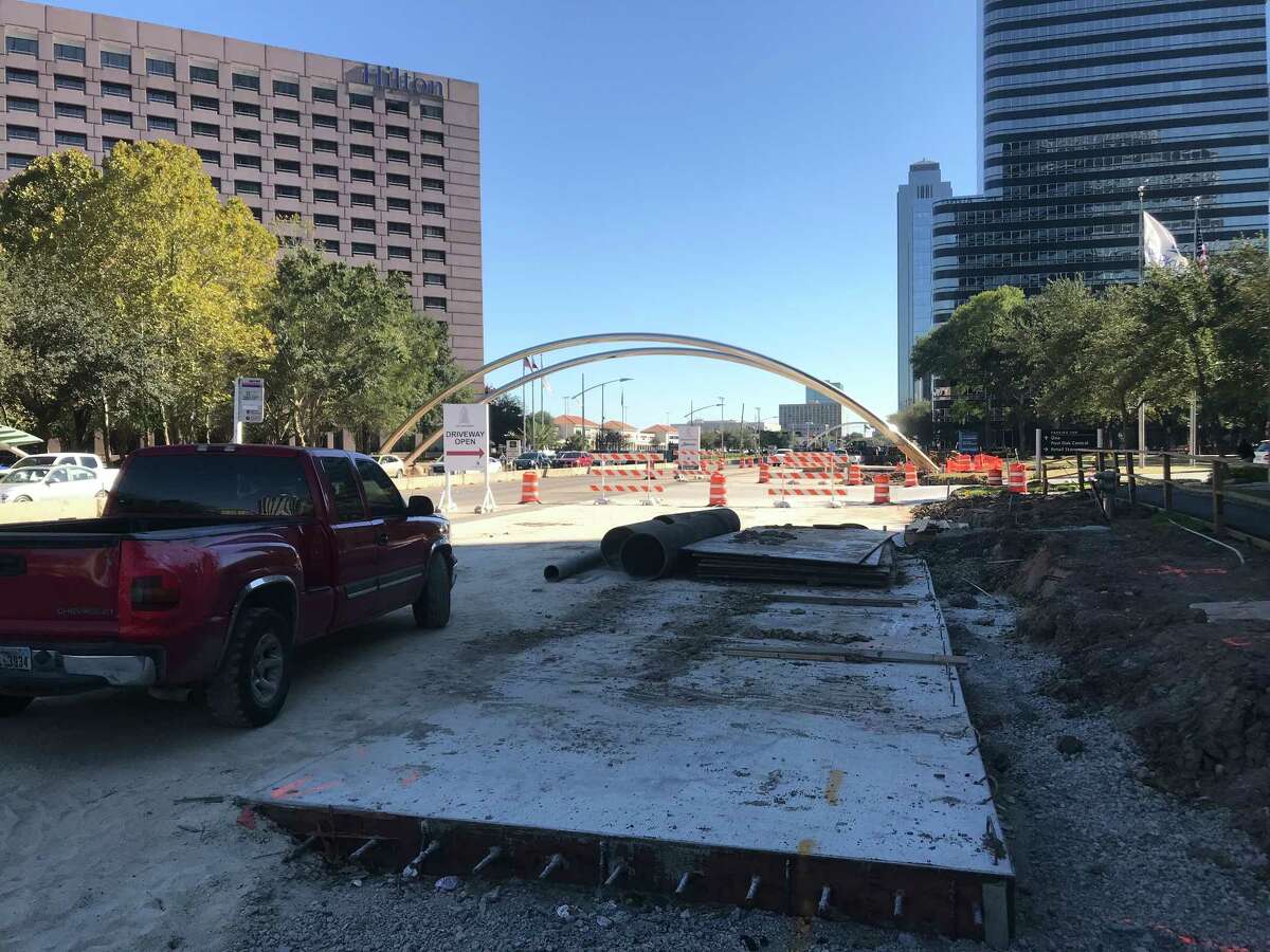 Crews continue work on Oct. 17 along the southbound side of Post Oak Boulevard, which is being widened for dedicated bus lanes through the Uptown area in Houston. Workers will also expand the iconic metal arches that line the street, and relocate one.