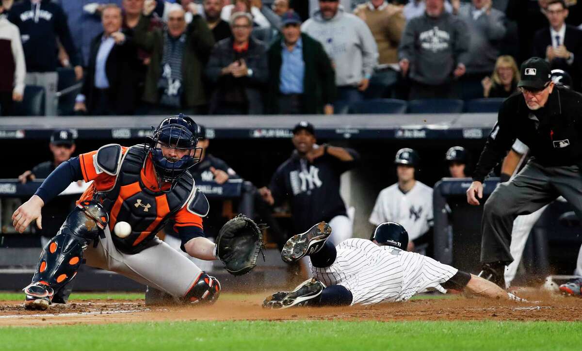 Brett Gardner slides past Astros catcher Brian McCann, left, to score during the third inning of Wednesday's Game 5 at Yankee Stadium. The Yankees outscored the Astros 19-5 in three games in the Bronx after a pair of 2-1 Astros wins at Minute Maid Park.