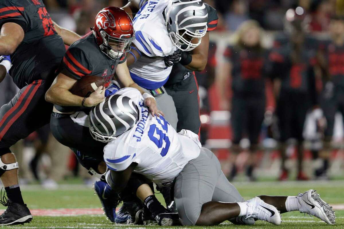 Houston Cougars quarterback Kyle Postma #3 scrambles and is tackled by Memphis Tigers defensive lineman Freddie Dillard #94 in the second quarter during the NCAA football game between the Memphis Tigers and the Houston Cougars at TDECU Stadium in Houston, TX on Thursday, October 19, 2017.