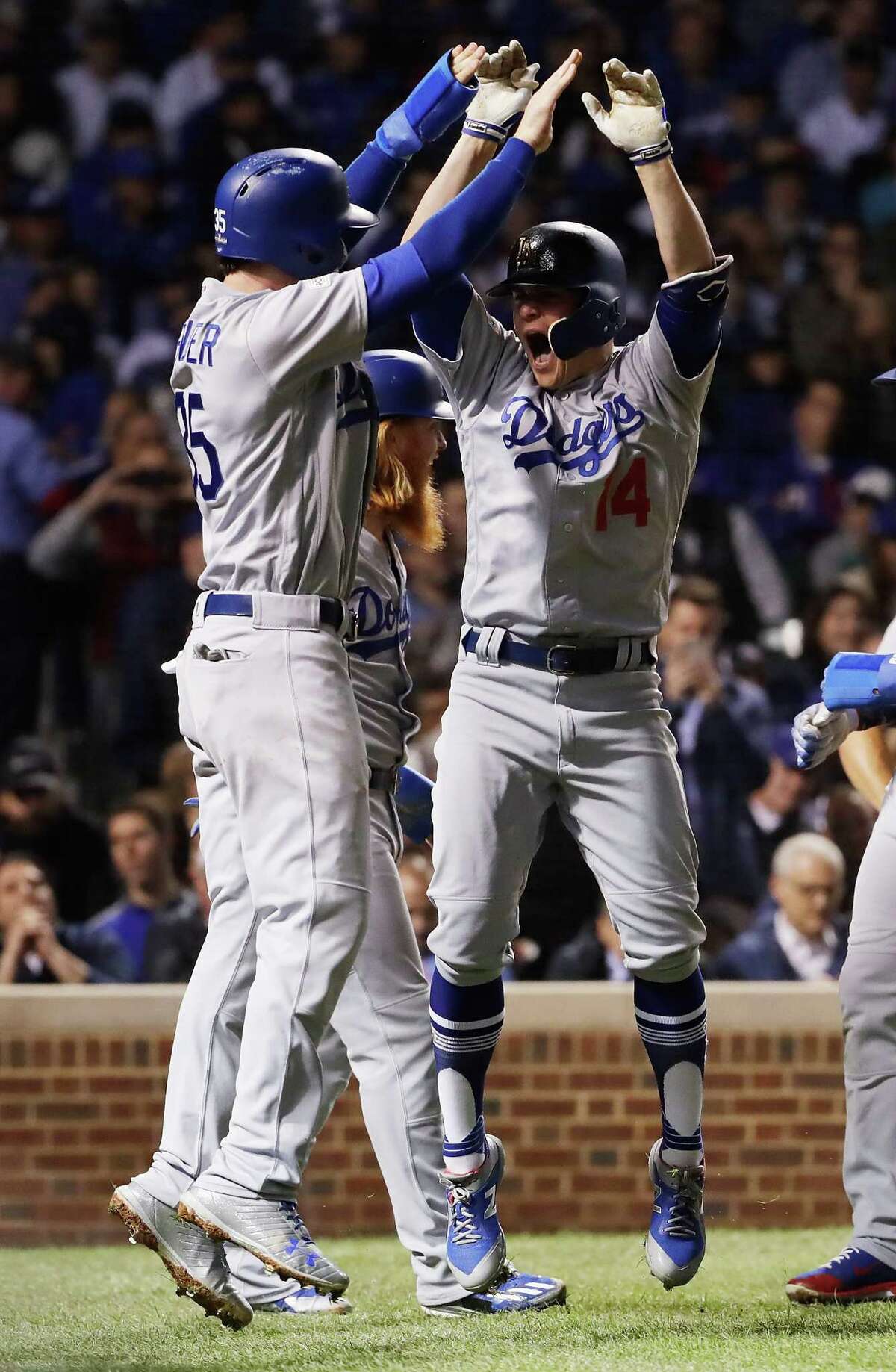 CHICAGO, IL - OCTOBER 19: Cody Bellinger #35 and Enrique Hernandez #14 of the Los Angeles Dodgers celebrate after Hernandez hit a grand slam in the third inning against the Chicago Cubs during game five of the National League Championship Series at Wrigley Field on October 19, 2017 in Chicago, Illinois. (Photo by Jamie Squire/Getty Images)