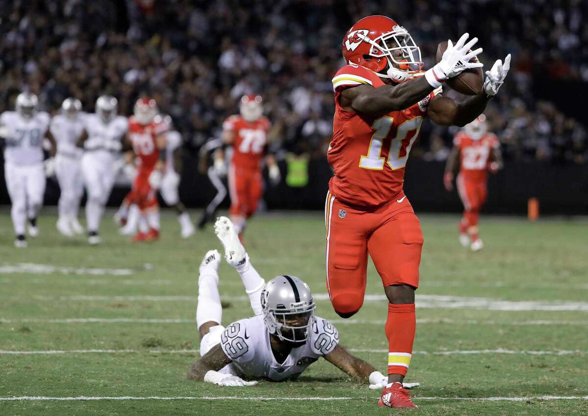 Kansas City Chiefs wide receiver Tyreek Hill (10) catches a touchdown past Oakland Raiders cornerback David Amerson (29) during the first half of an NFL football game in Oakland, Calif., Thursday, Oct. 19, 2017. (AP Photo/Marcio Jose Sanchez)