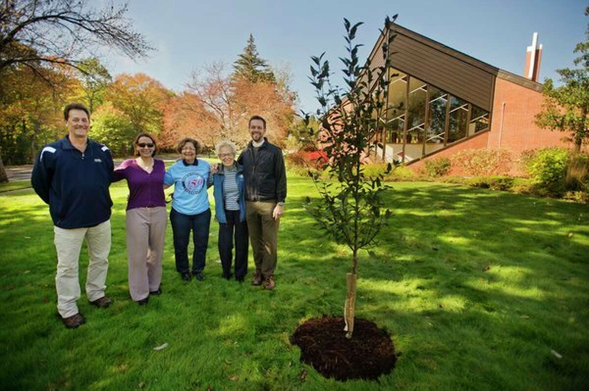 From left, Mike Reder with Reder Landscaping; Carol Sullivan, ministry coordinator with St. John's Episcopal Church; Carole Adams and Faye Ebach, anniversary committee co-chairs with St. John's Episcopal Church, and The Rev. Ken Hitch pose for a photo next to a crabapple tree they planted in celebration of the church's 150th anniversary in Midland. (Katy Kildee/kkildee@mdn.net)