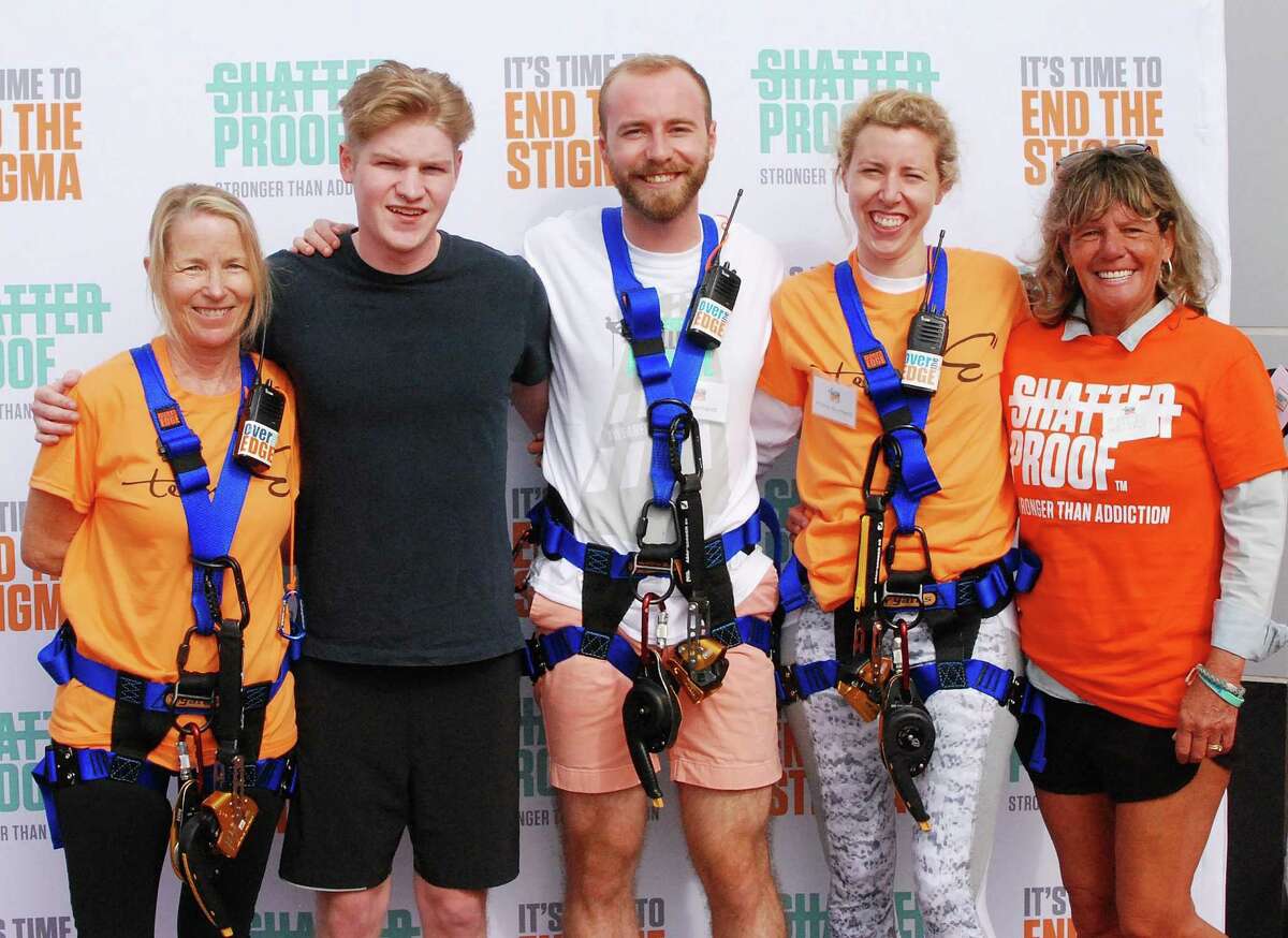 Kim Hyde and Andrew Hyde, of Rowayton, Karl Reinhardt and Andrea Reinhardt, of New Canaan, and Cappy Waters, of Darien, rappelled down 22 stories at Stamfords Beacon Harbor Point Oct. 7 to raise money to fight addiction.