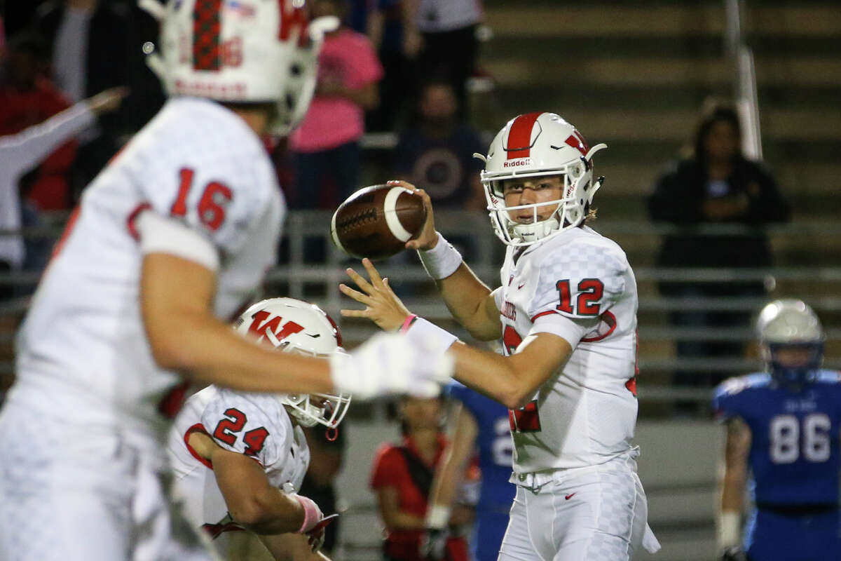 The Woodlands quarterback Quinton Johnson (12) throws a pass to wide receiver Connor Klapesky (16) during the varsity football game against Oak Ridge on Friday, Oct. 20, 2017, at Woodforest Bank Stadium.