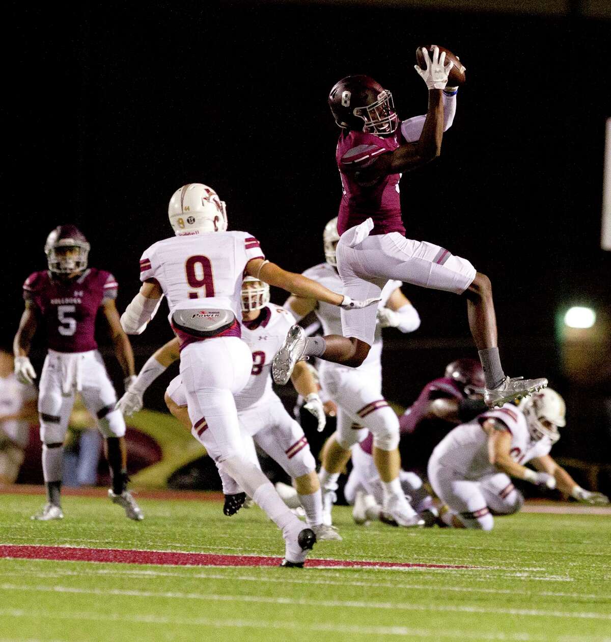 Magnolia wide receiver Michael Woods (8) catches a high pass from quarterback Reese Mason during the first quarter of a District 20-5A high school football game, Friday Oct. 20, 2017, in Magnolia.