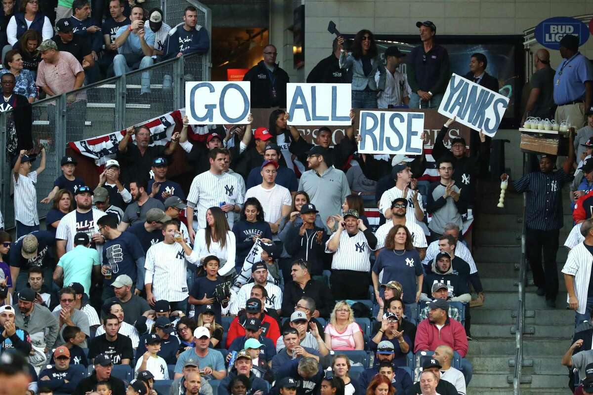 Fans cheer during the first inning between the Houston Astros and the New York Yankees in Game 5 of the ALCS at Yankee Stadium.