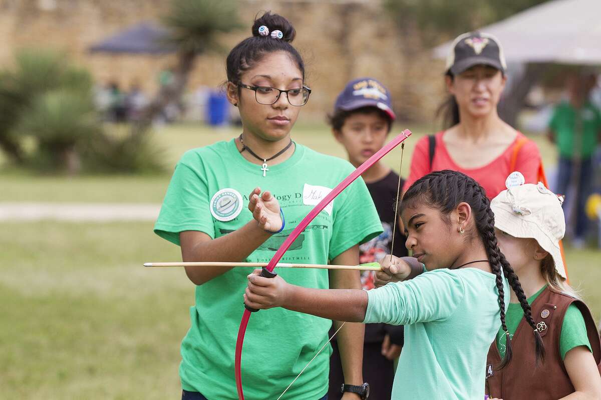 Maddi Rios, 8, shoots an arrow Saturday as part of Archeology Day at Mission San José.