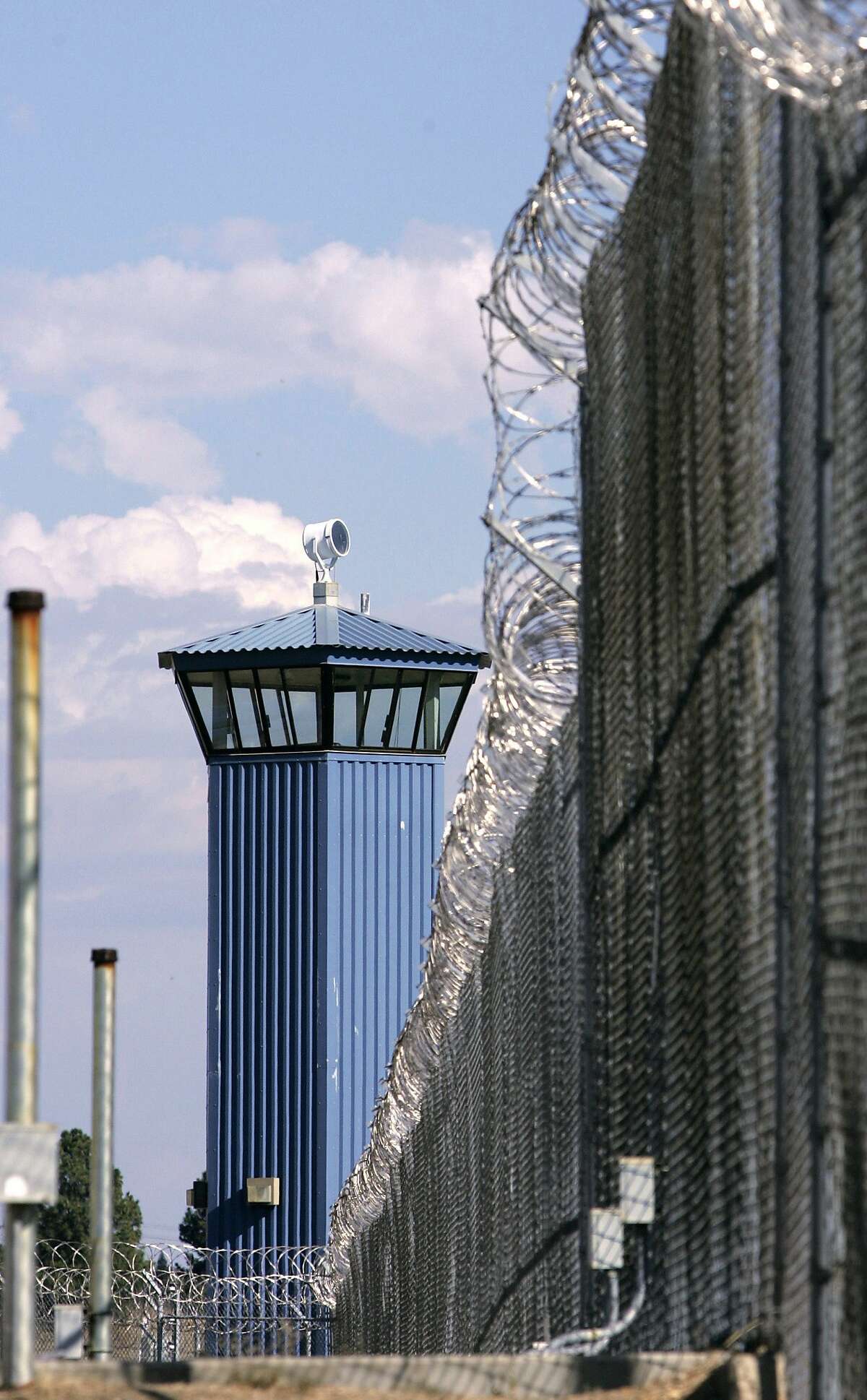 FILE - In this Aug. 31, 2007 file photo, a guard tower stands behind the wire fence that surrounds California State Prison, Sacramento, in Folsom, Calif. Corrections officials say one inmate is dead and several others have been taken to an outside hospital to be treated for stab winds after a riot broke out at one of the prison's exercise yard, Wednesday, Aug. 12, 2015.(AP Photo/Rich Pedroncelli, File)