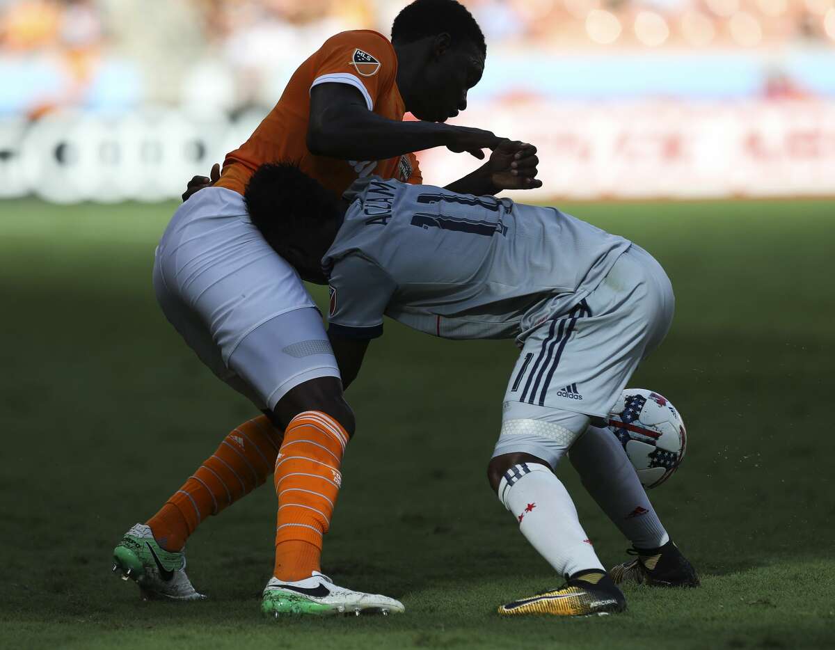 Houston Dynamo defender Jalil Anibaba (2) and Chicago Fire forward David Accam (11) tangle together while battling for control of the ball during the second half of the last MLS regular game at BBVA Compass Stadiujm on Sunday, Oct. 22, 2017, in Houston. The Houston Dynamo defeated the Chicago Fire 3-0. ( Yi-Chin Lee / Houston Chronicle )