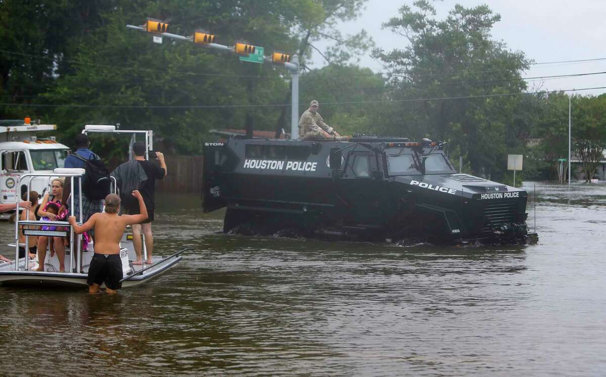 Members of the Houston Police Department ride in a department-owned MRAP through the flooded intersection of W. Belfort and Runnymeade in Meyerland, Sunday, Aug. 27, 2017, in Houston. (Mark Mulligan / Houston Chronicle)