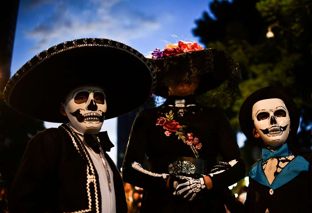 People fancy dressed as "Catrina" take part in the "Catrinas Parade" along Reforma Avenue, in Mexico City on October 22, 2017. Mexicans get ready to celebrate the Day of the Dead highlighting the character of La Catrina which was created by cartoonist Jose Guadalupe Posada, famous for his drawings of typical local, folkloric scenes, socio-political criticism and for his illustrations of "skeletons" or skulls, including La Catrina.
