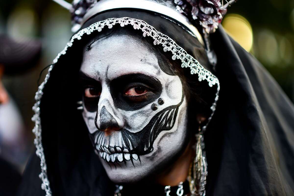 A woman disguised as "Catrina" (Mexican representation of death) ...