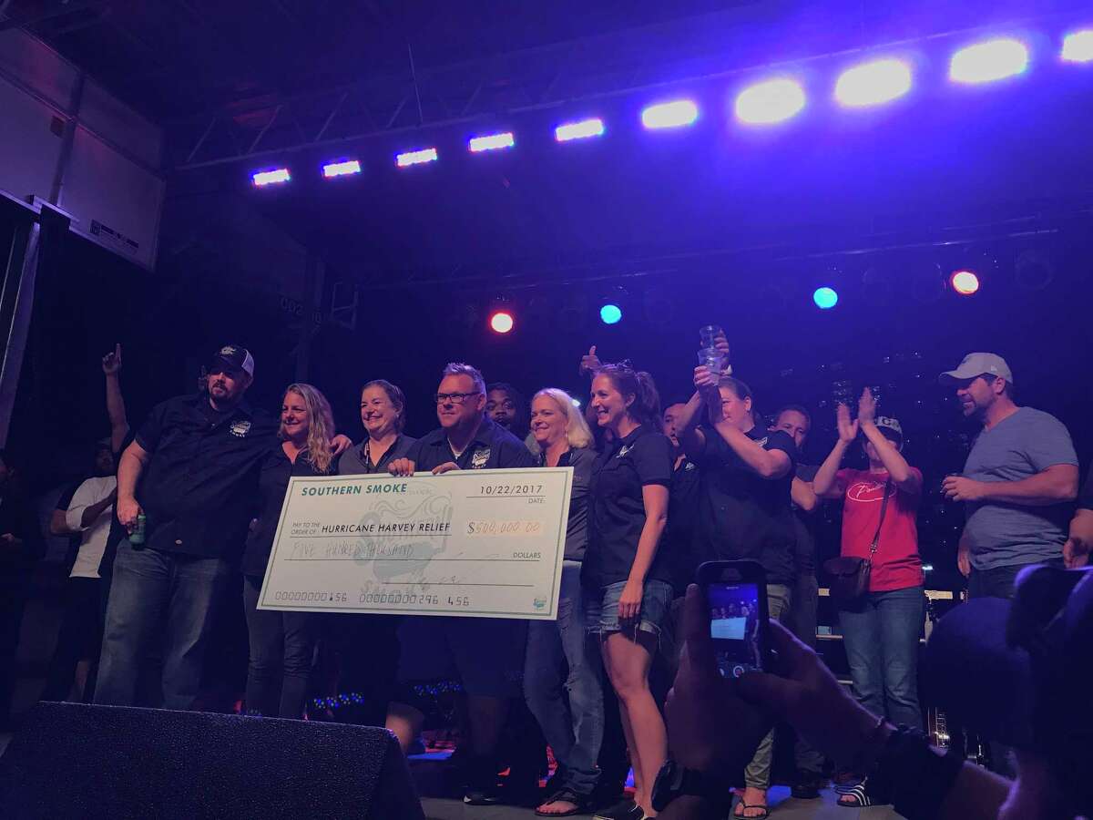 Chris Shepherd, center, holds a check for $500,000, which was raised by his Southern Smoke event benefiting hospitality workers affected by Hurricane Harvey.