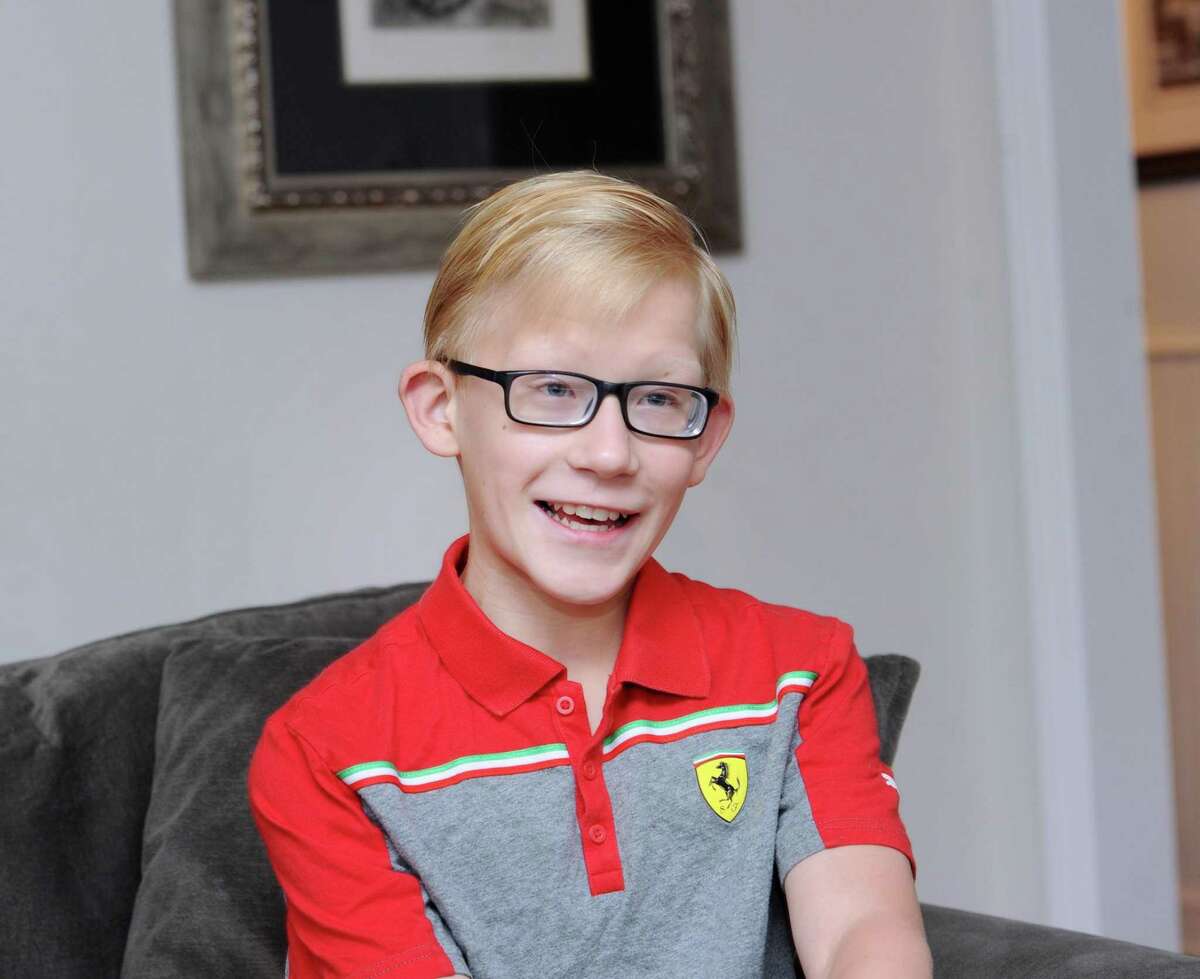 Connor O’Neill, 11, speaks about his Make-A-Wish Foundation Mediterranean cruise that he took last year at his home in Darien. He is wearing a Ferrari Automobile shirt that he got during his trip.