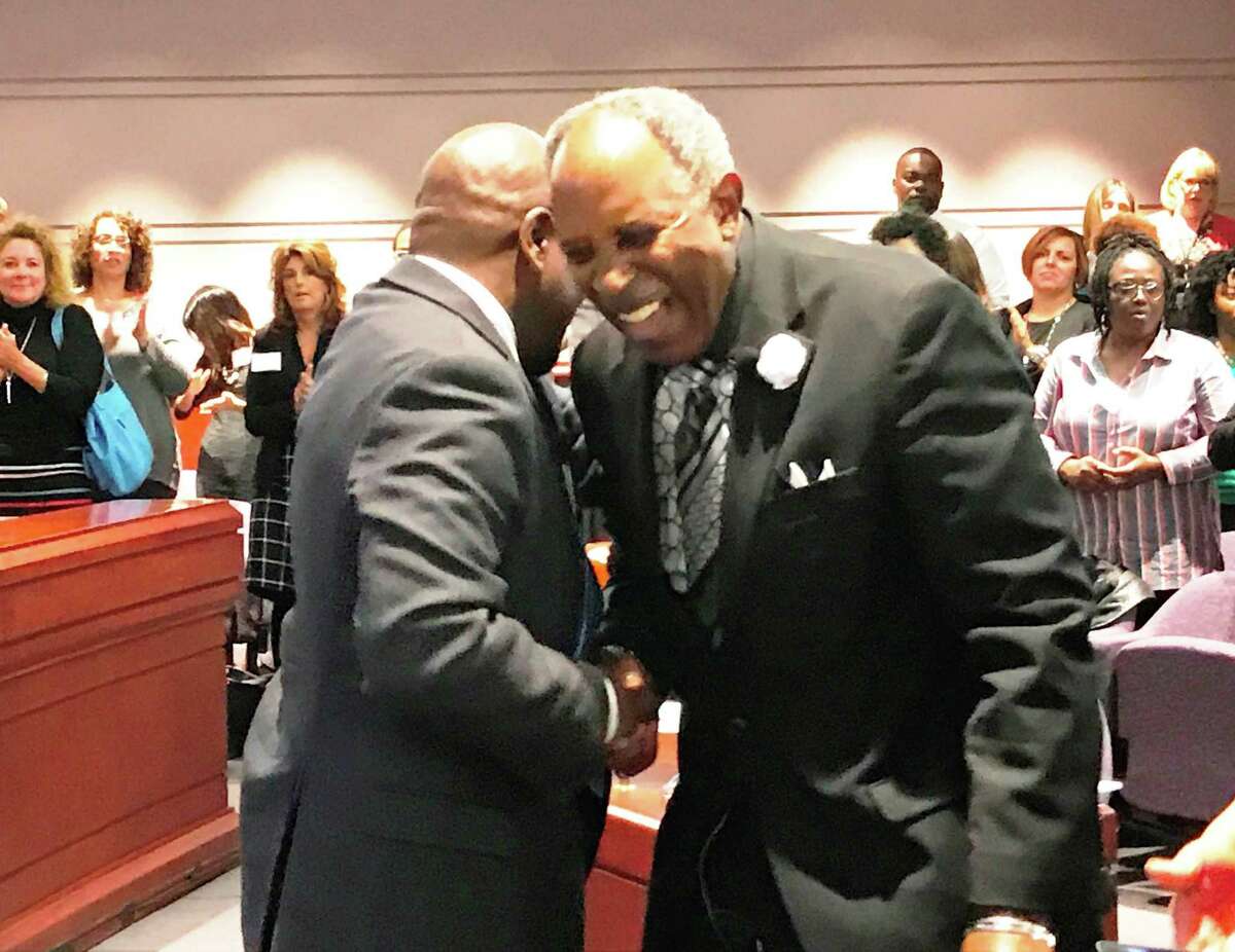 Supreme Court Justice Richard Robinson, left, shares a moment with retired state Supreme Court Justice Lubbie Harper Jr. Monday.