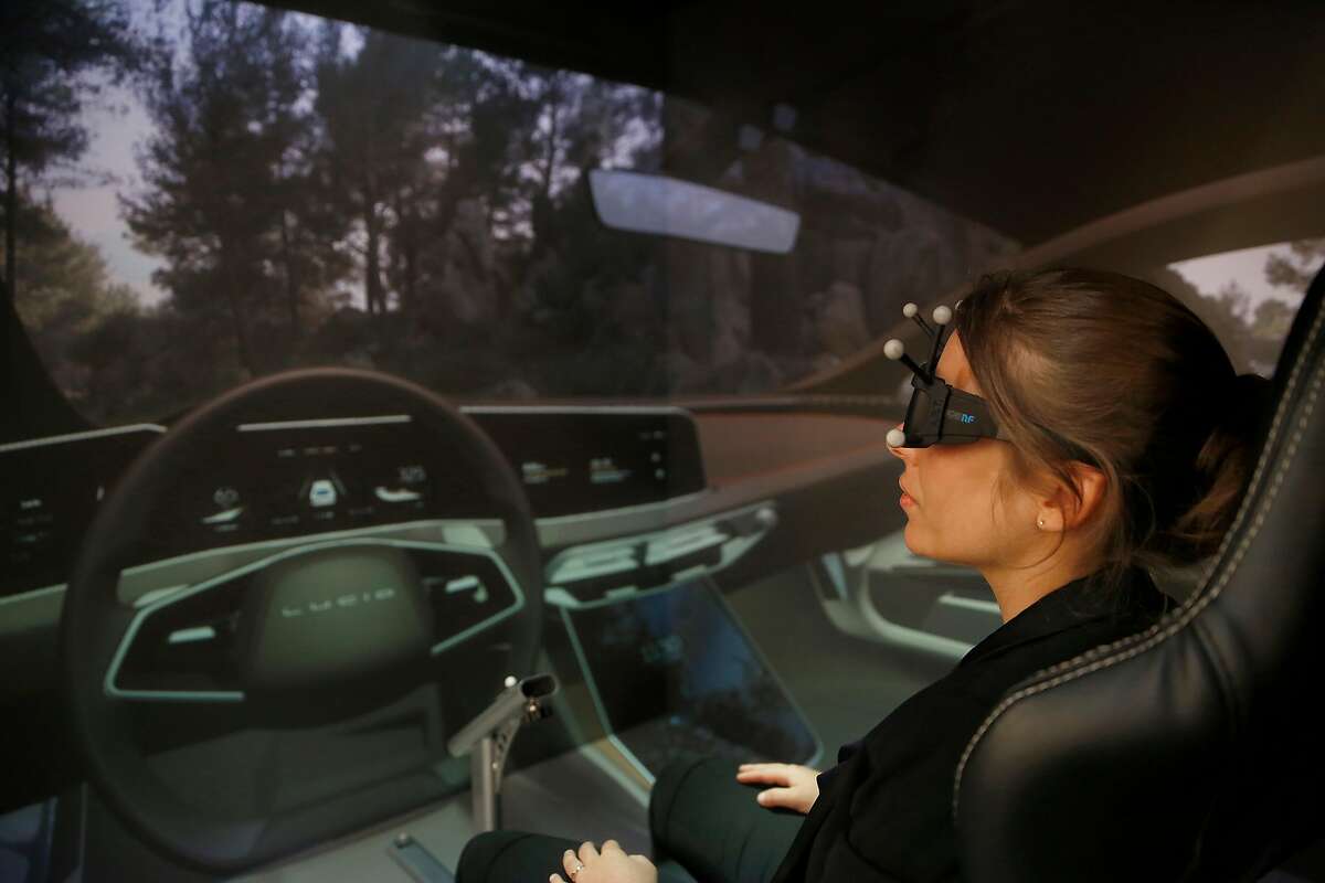 Applications engineer Sandra Gely demonstrates the OPTIS virtual reality demo center during a press preview on Monday October 23, 2017, in San Jose, Calif.
