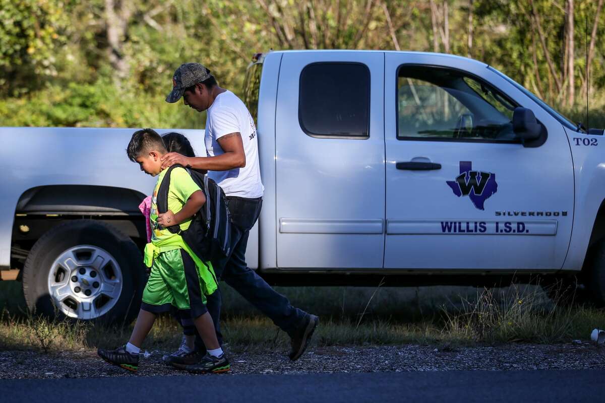 Parents retrieve their children from the scene of a 4-vehicle collision that involved a Willis ISD school bus with 39 children on board on Monday, Oct. 23, 2017, south of Willis on Texas 75.