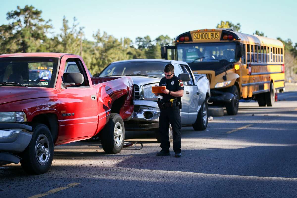 First responders investigate the scene of a 4-vehicle collision that involved a Willis ISD school bus with 39 children on board on Monday, Oct. 23, 2017, south of Willis on Texas 75.